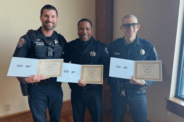 Three APD Officers holding 