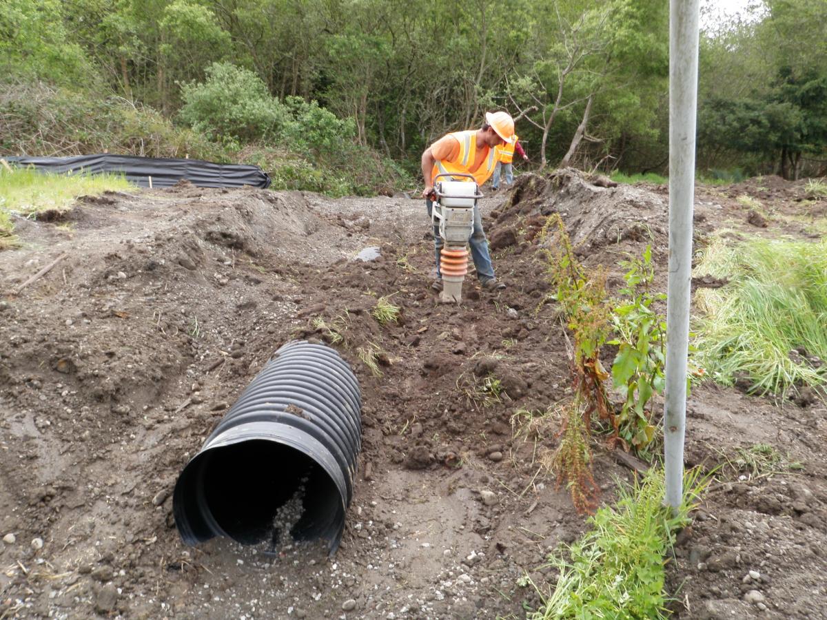 Construction Worker Compacting Soil